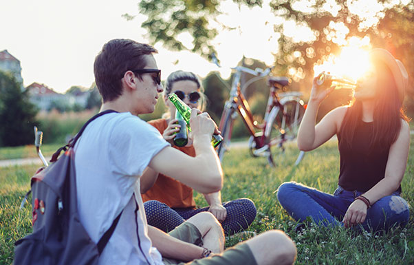 Friends drinking in park